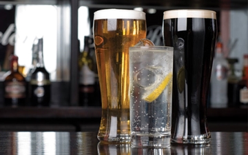 Alcoholic and soft drinks (Beer, Guiness and Lemonade) on a bar.  Image is used to support the hospitality sector in the UK.
